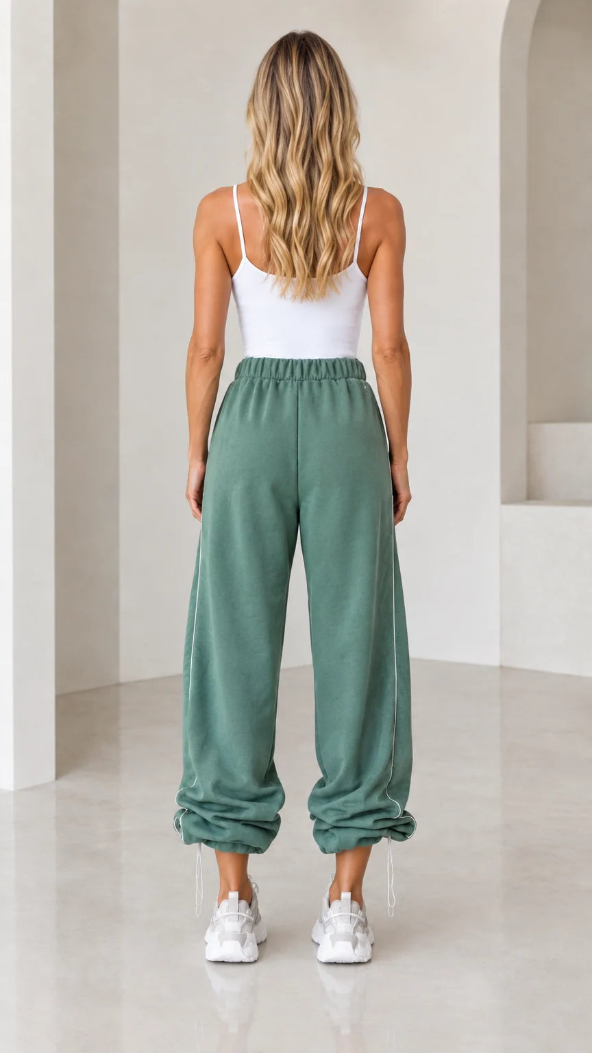 Back view of model wearing sage green wide-leg joggers with gathered ankles