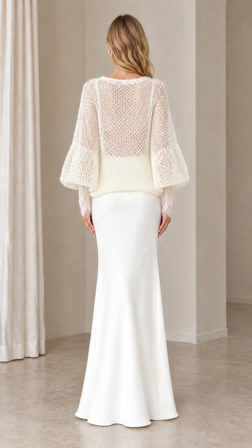 Back view of woman in Ivory open-knit long sleeve cardigan and maxi skirt