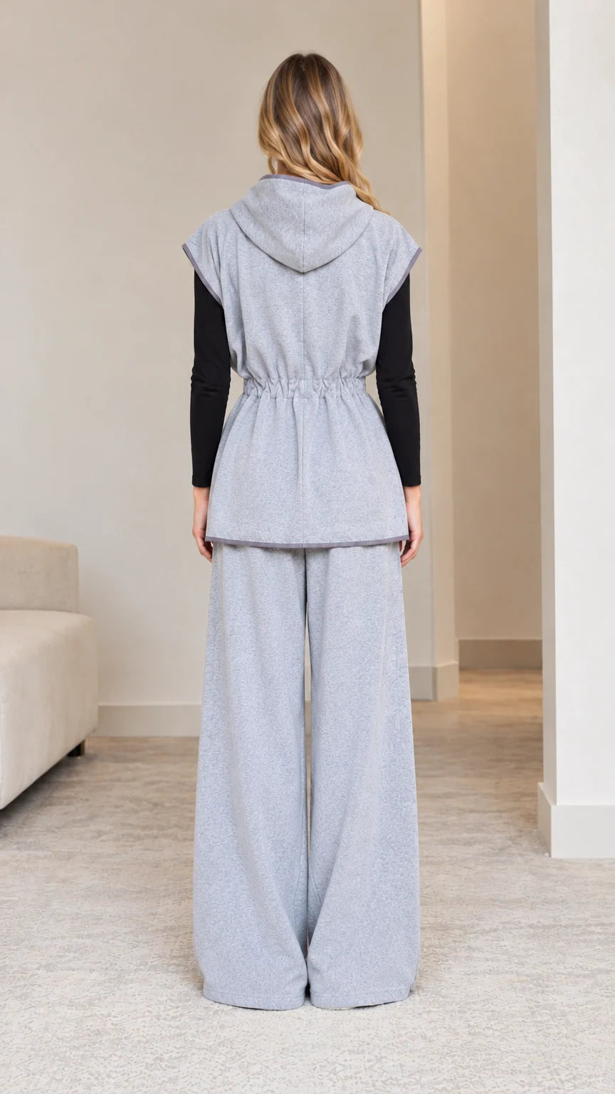 Back view of model wearing heather grey hooded loungewear set with wide legs