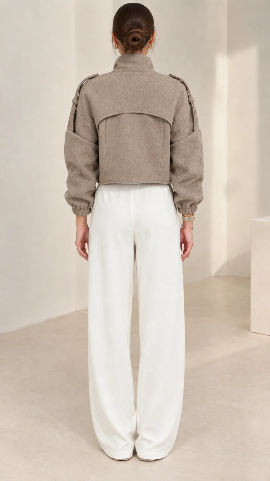 Back view of taupe cropped zip-up jacket highlighting clean back yoke design