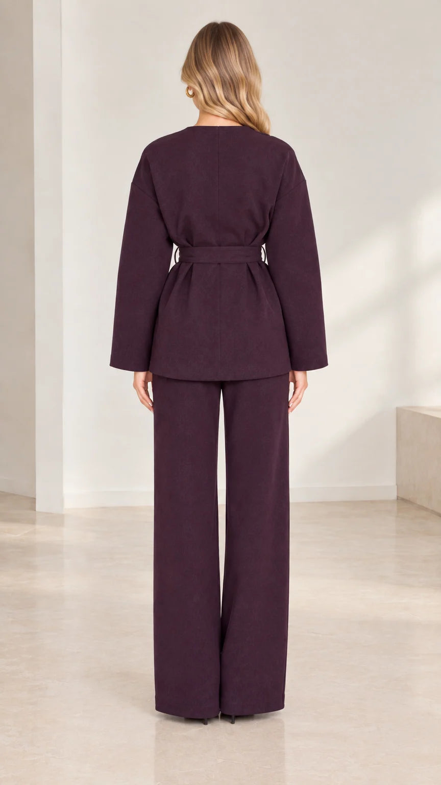 Back full-length view of deep plum long-sleeve belted tunic and wide trousers