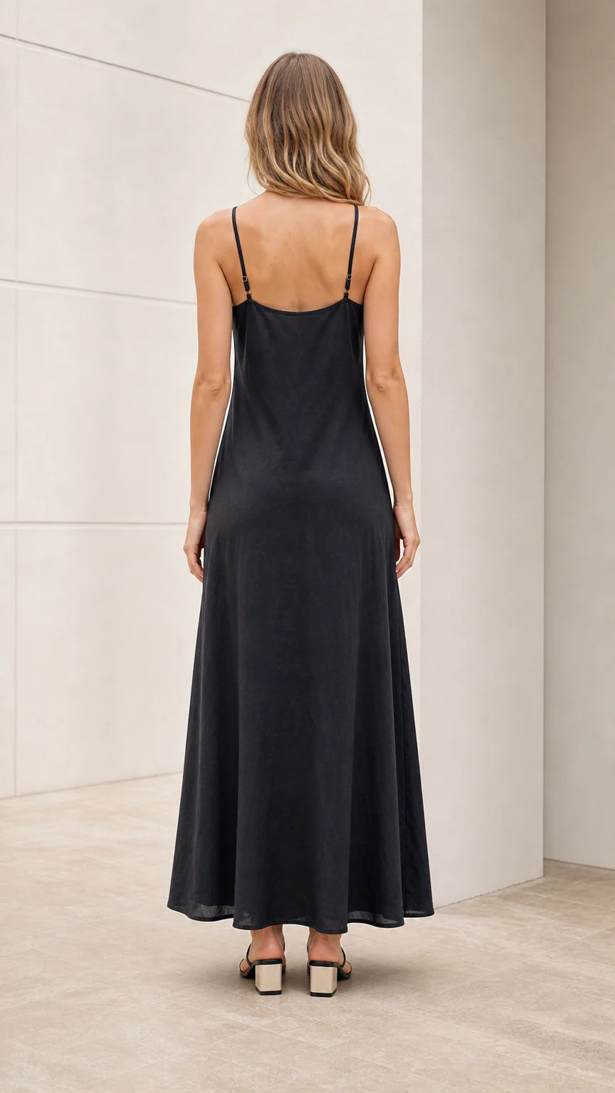 Model wearing black slip dress back view