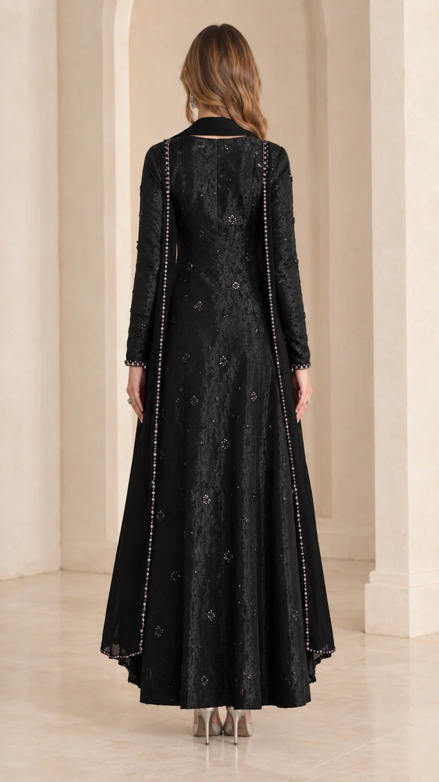 Back view of black long sleeve A-line maxi dress with matching scarf drape