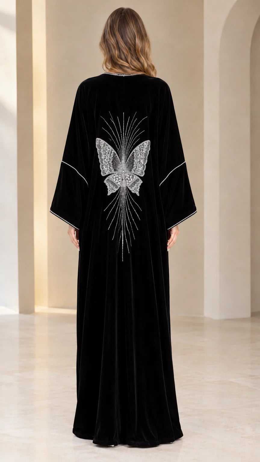 Back view of black velvet abaya featuring a detailed crystal butterfly design