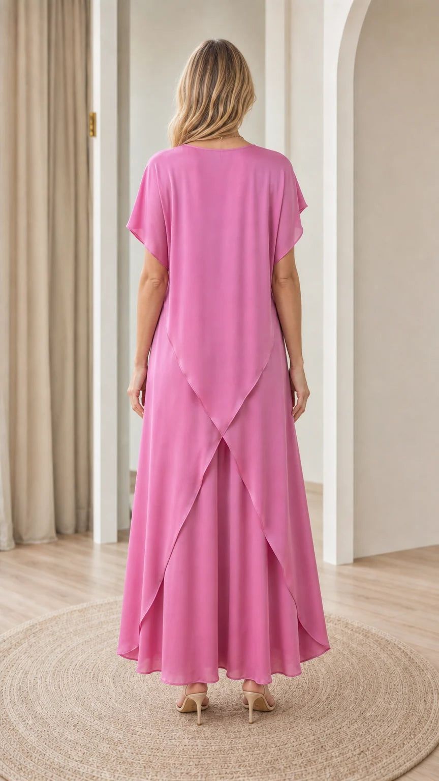 Back view of model showing the symmetrical tulip split hem detail on fuchsia pink tunic set