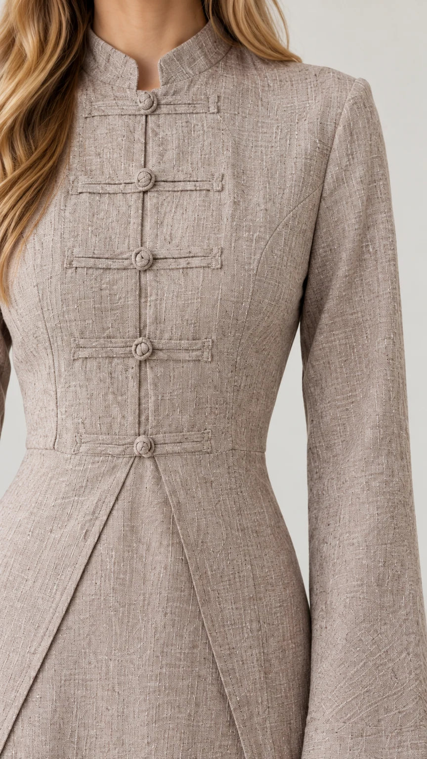 Close-up of textured oatmeal bodice with traditional knotted frog buttons