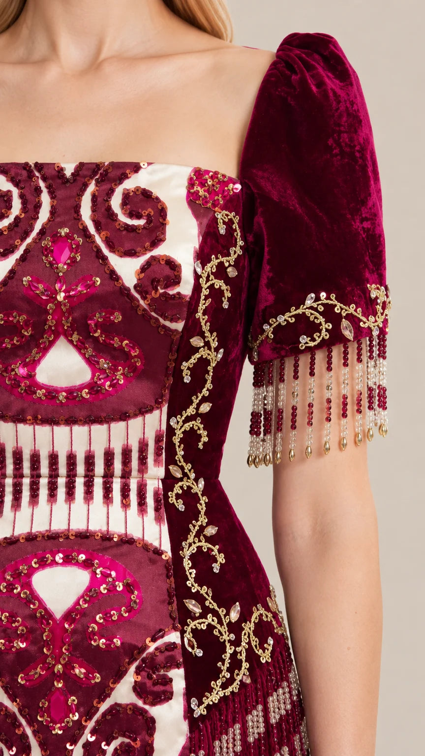 Close-up detail of Burgundy gown bodice showing ornate embroidery and beaded sleeve fringe