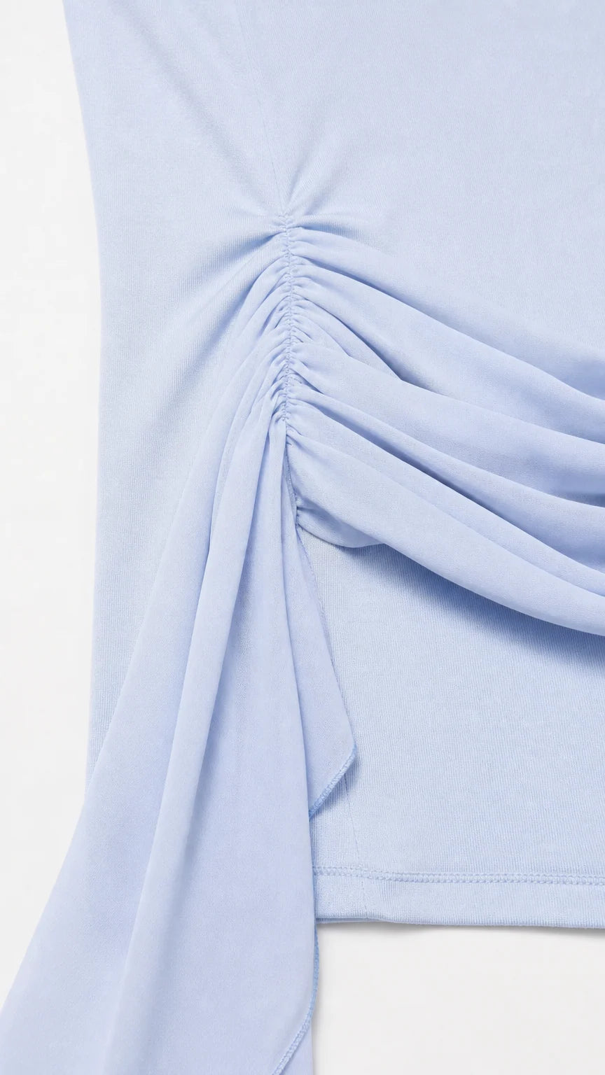 Close-up detail of hip ruching and fabric sash
