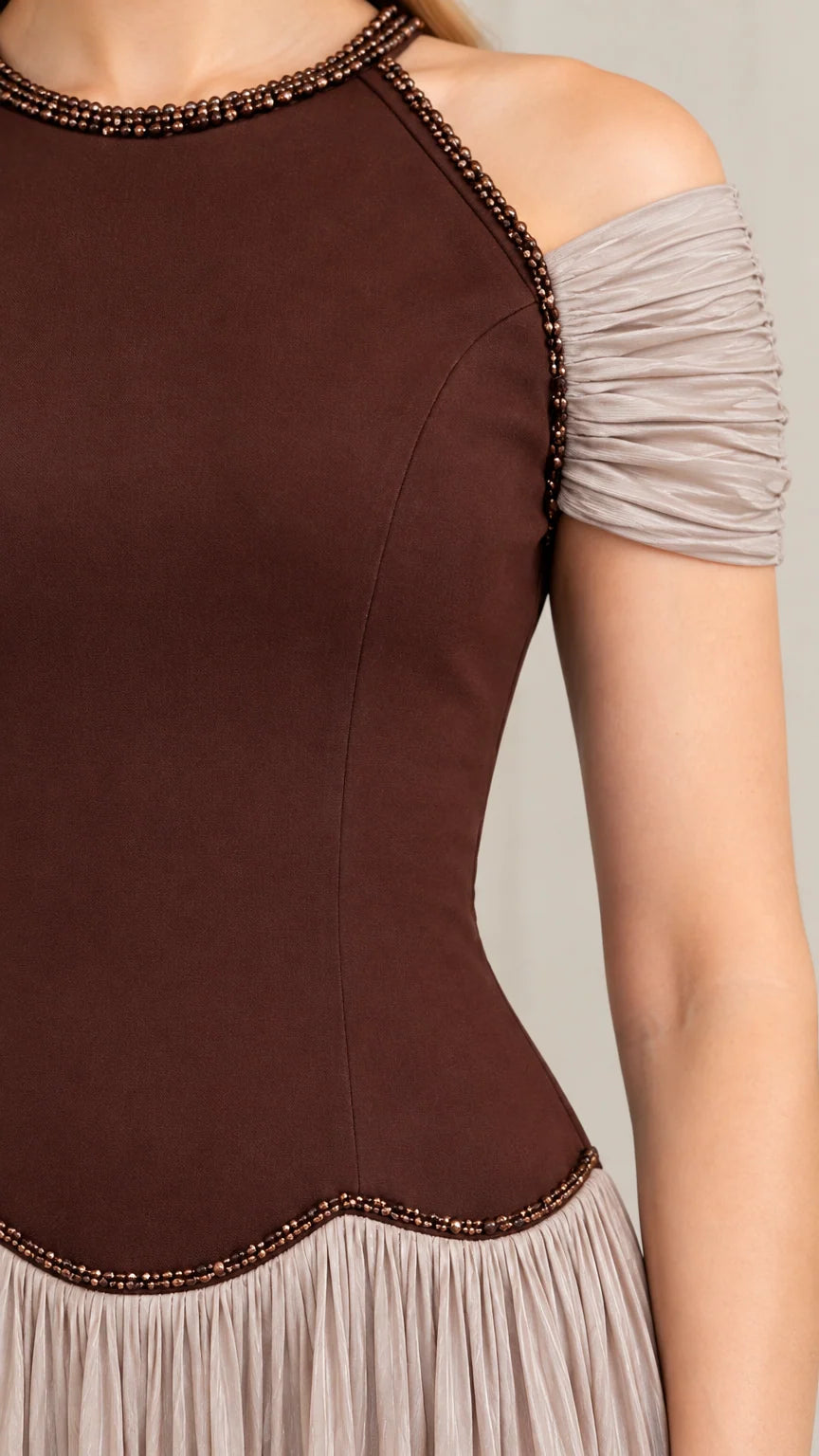 Close-up detail of beaded neckline and textured bodice of chocolate brown dress
