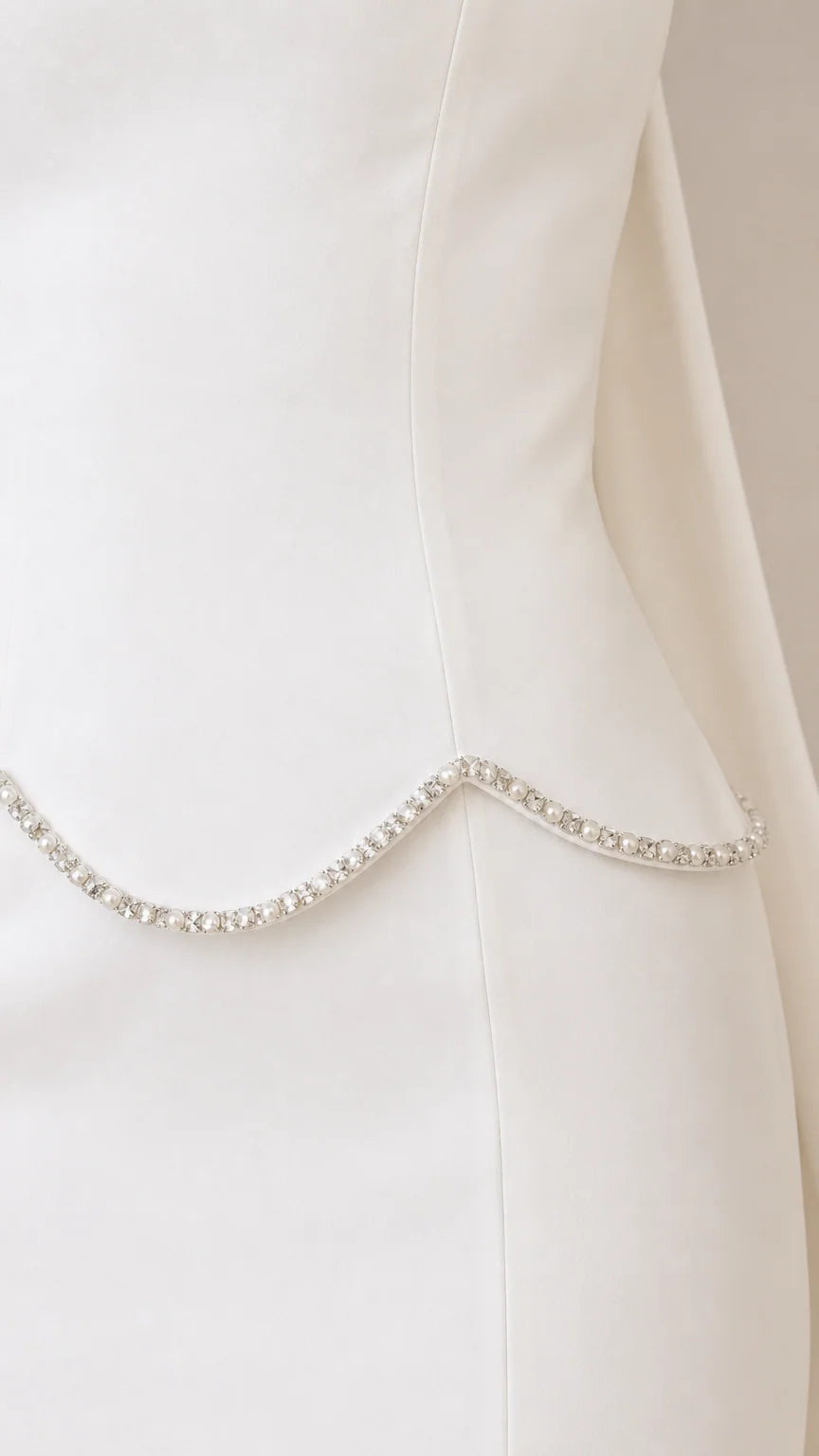 Close-up of sparkling rhinestone trim along the scalloped waistline