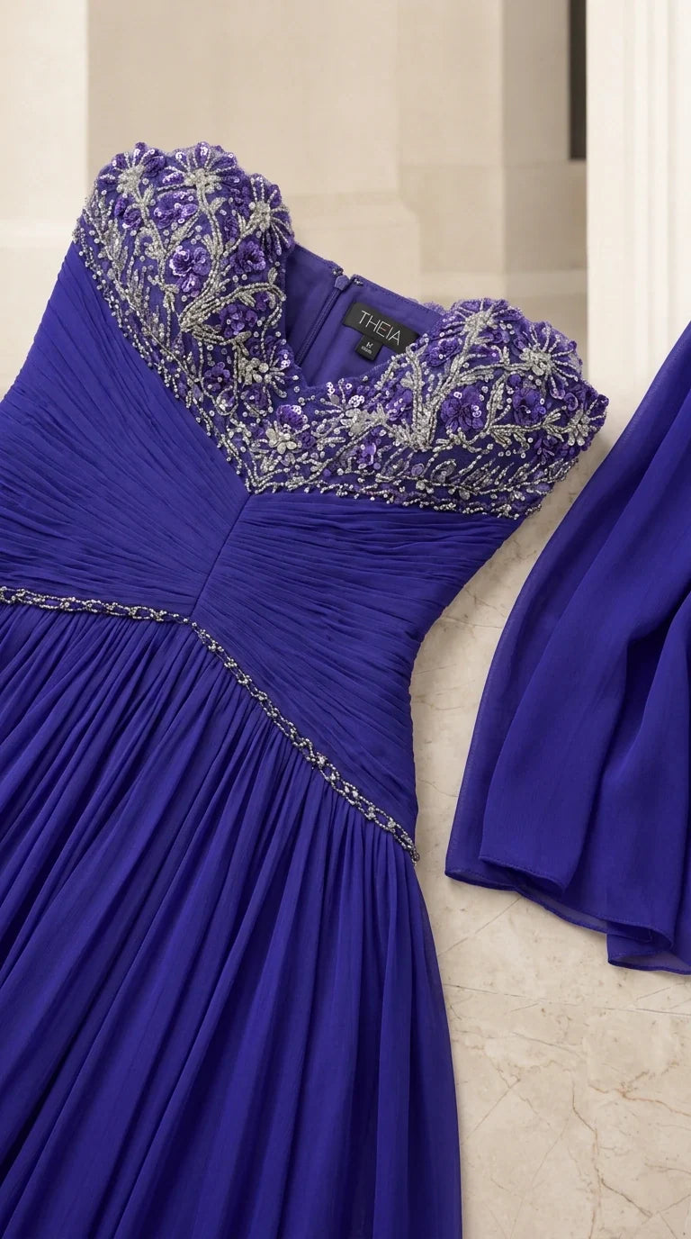 Close-up detail of beaded and crystal embroidered sweetheart neckline on royal blue chiffon gown