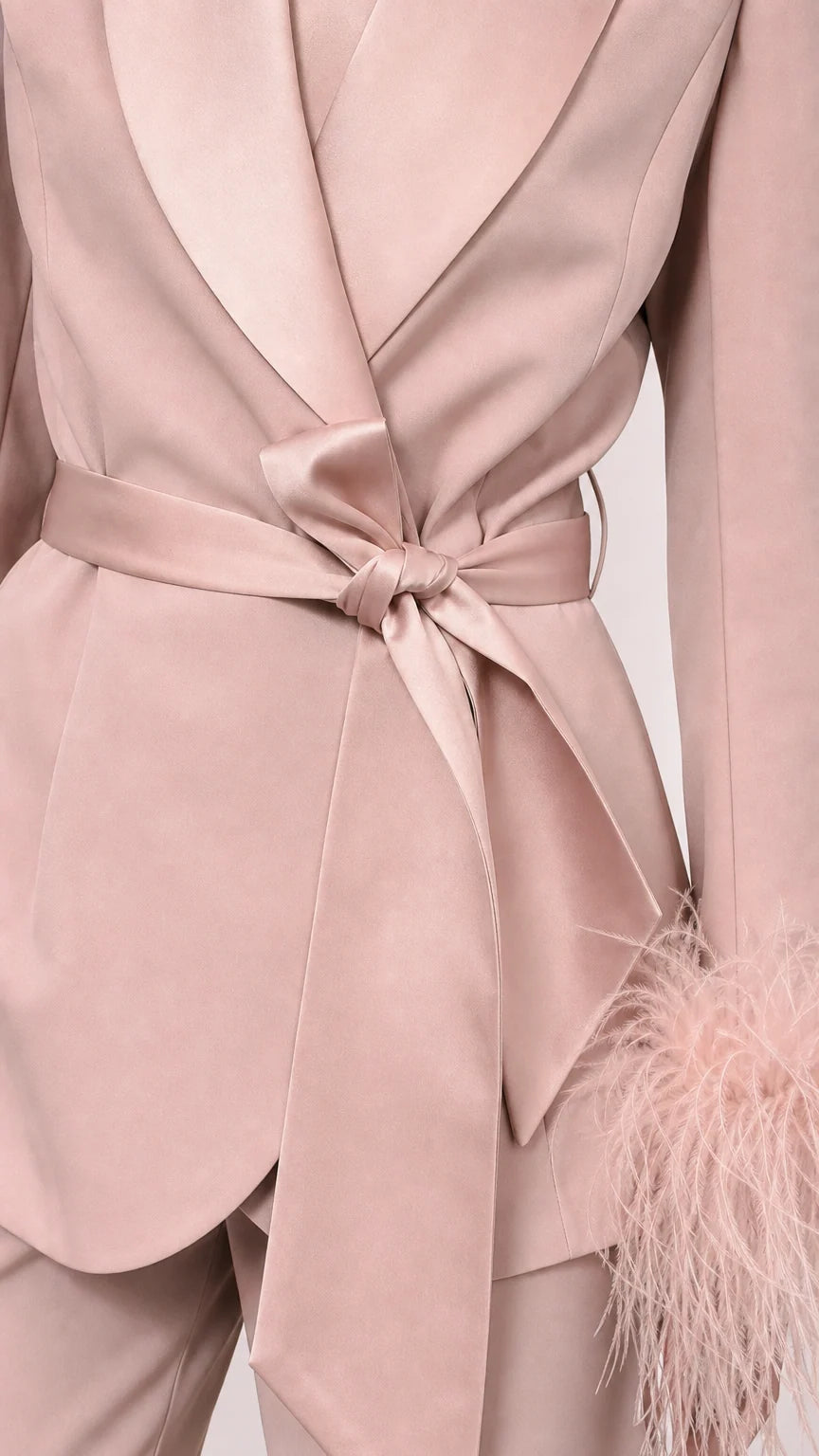 Close-up of pink satin blazer wrap tie and lapel detail