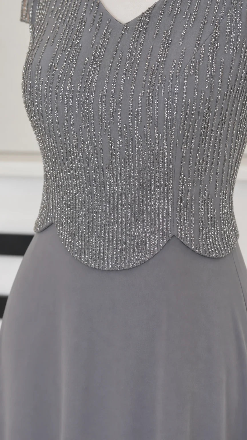 Close-up detail of Slate Gray beaded bodice with scalloped waist trim