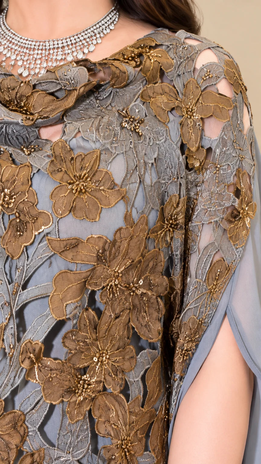 Close-up detail of golden floral lace embroidery and beadwork on dusty blue gown