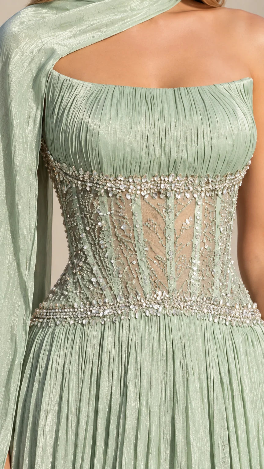 Close-up detail of beaded illusion corset bodice and pleated neckline on sage green gown