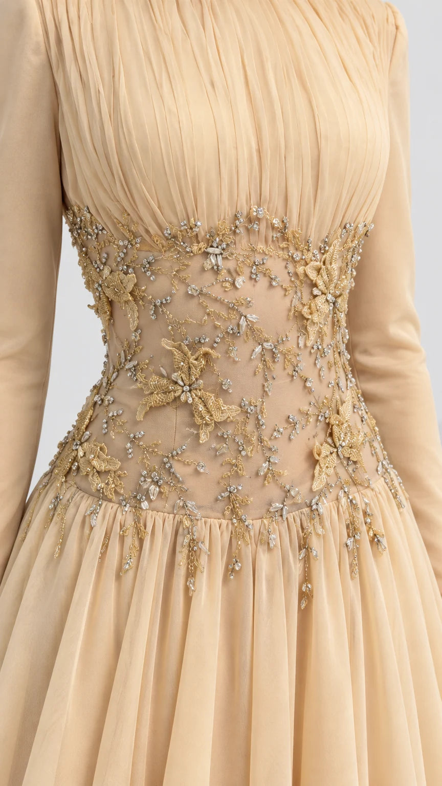Close-up of intricate floral beadwork and pleating on Champagne evening gown