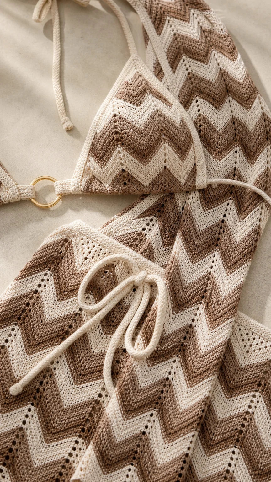 Close-up detail of beige chevron pattern and hardware