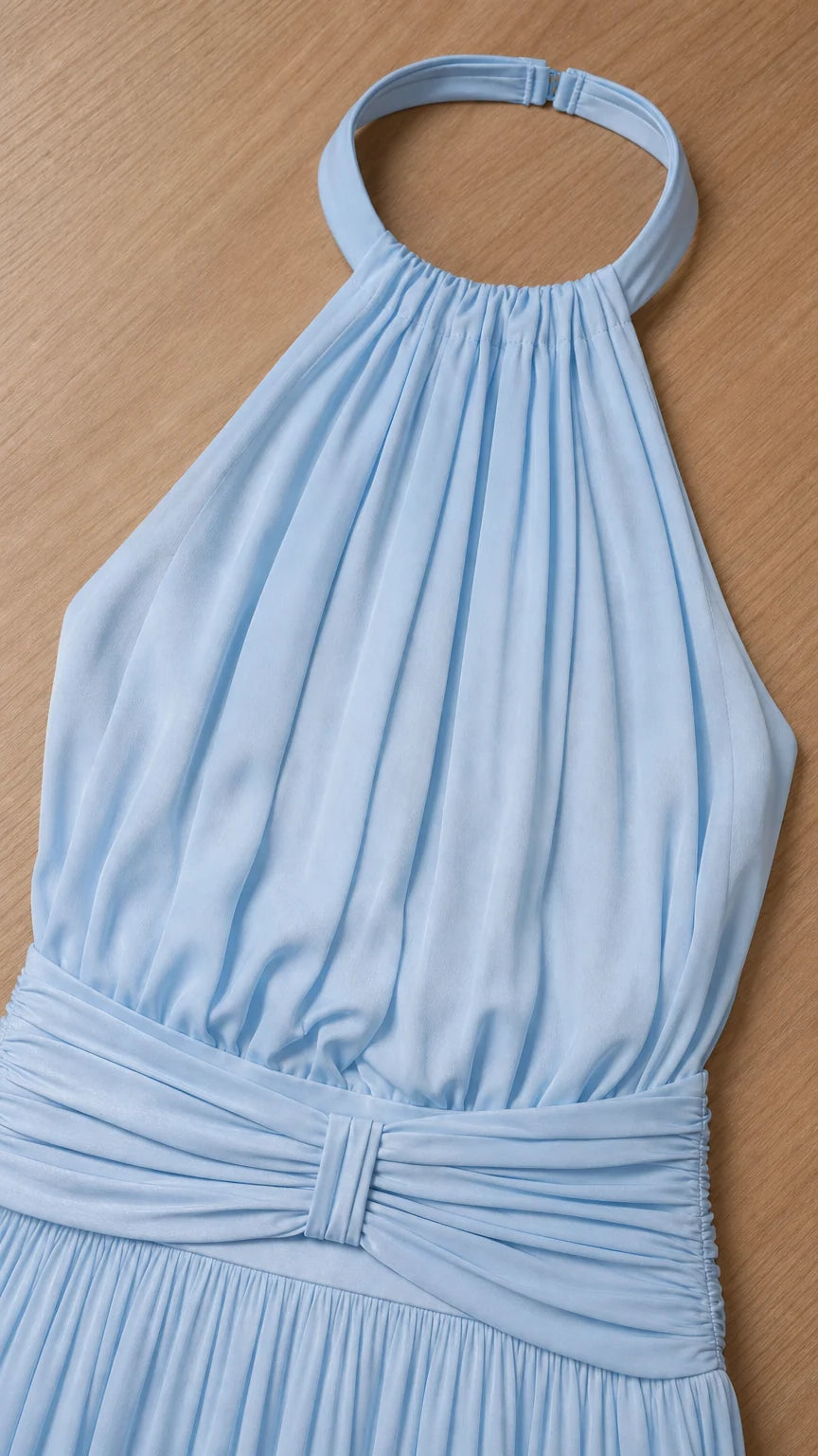 Close up of halter neckline and pleated bodice detail in light blue