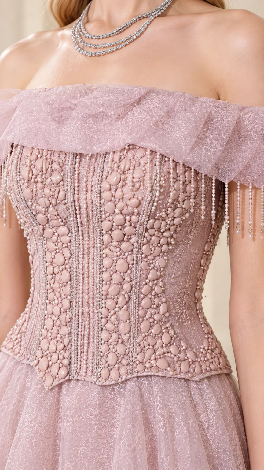 Close-up detail of beaded corset bodice with fringe tassels and tulle collar