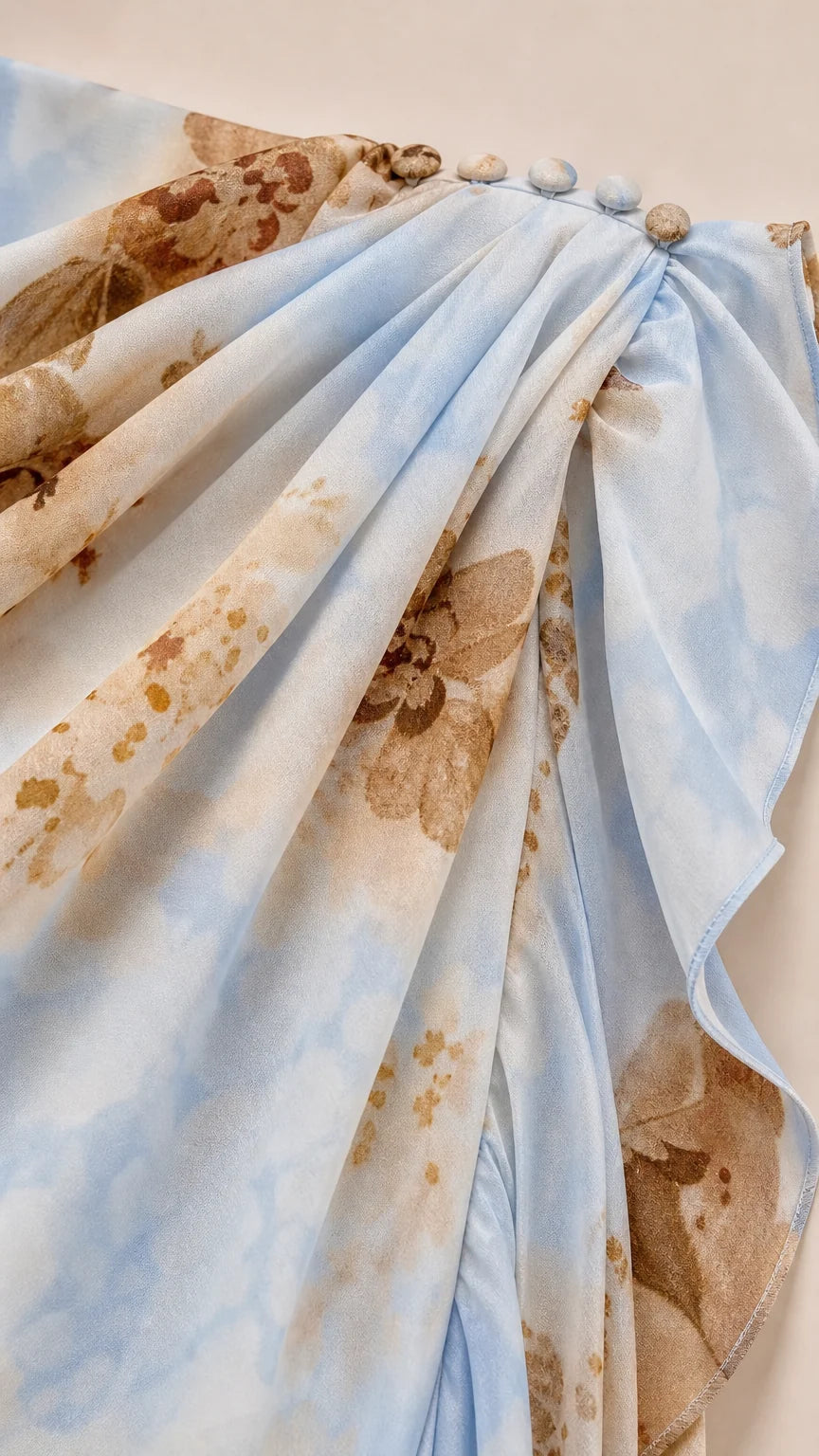 Close-up of shoulder button closure and ruffled fabric texture in Light Blue