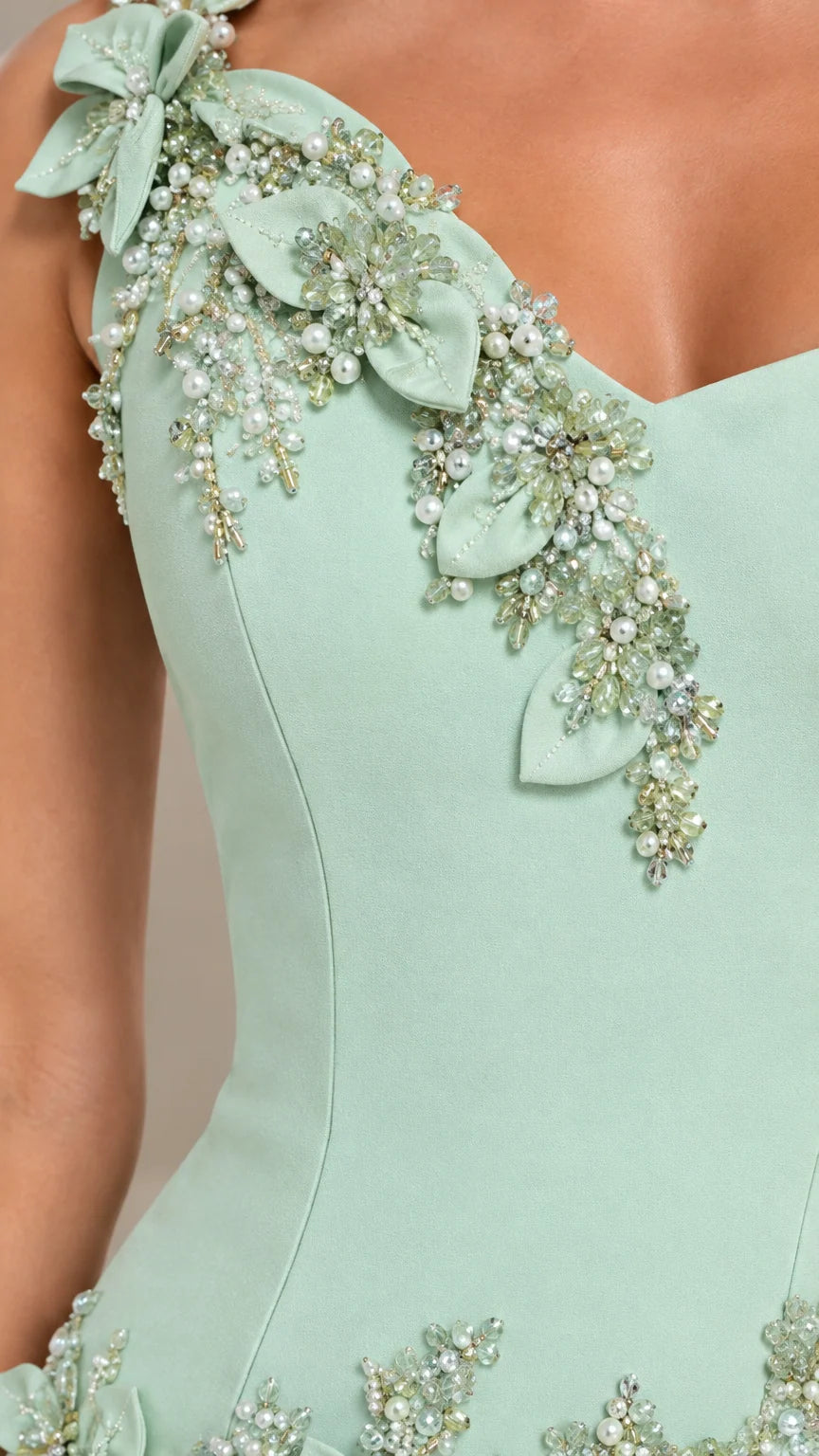 Close-up of beaded 3D floral appliqué detail on mint green gown neckline