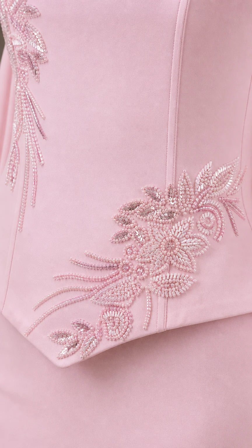 Close-up of delicate tonal floral beadwork and embroidery on bodice hem