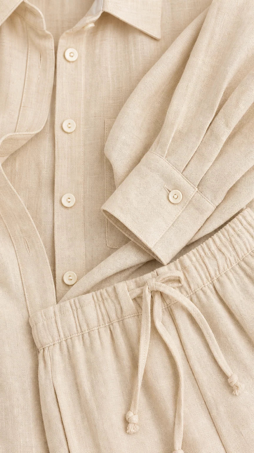 Close-up detail of beige button-down shirt cuff and drawstring pant waistband