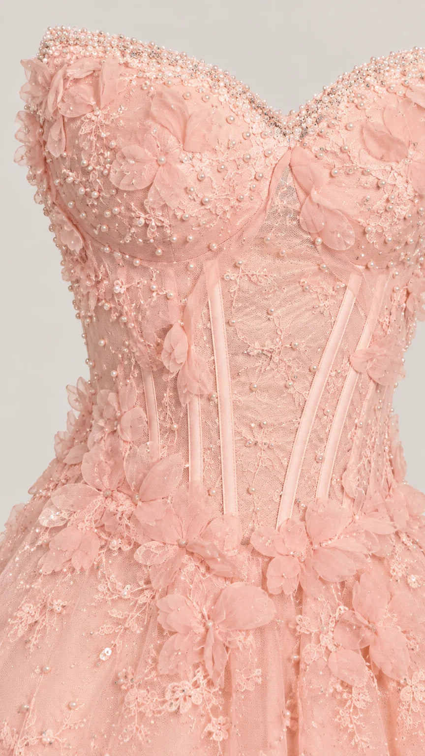 Close-up detail of bodice featuring sweetheart neckline, pearl beading, boning, and 3D floral lace