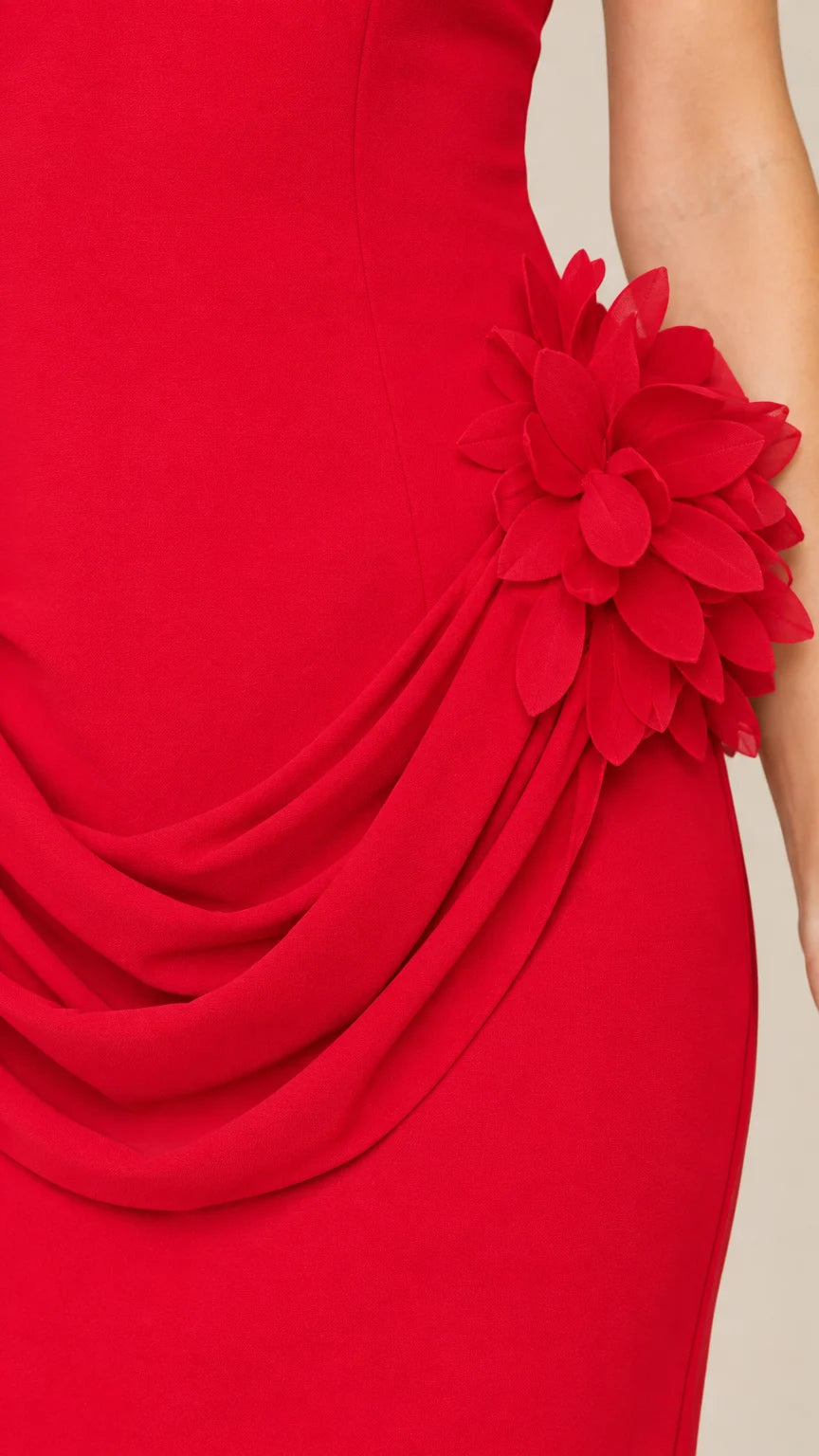 Close up of 3D floral applique and pleated drape on red maxi dress