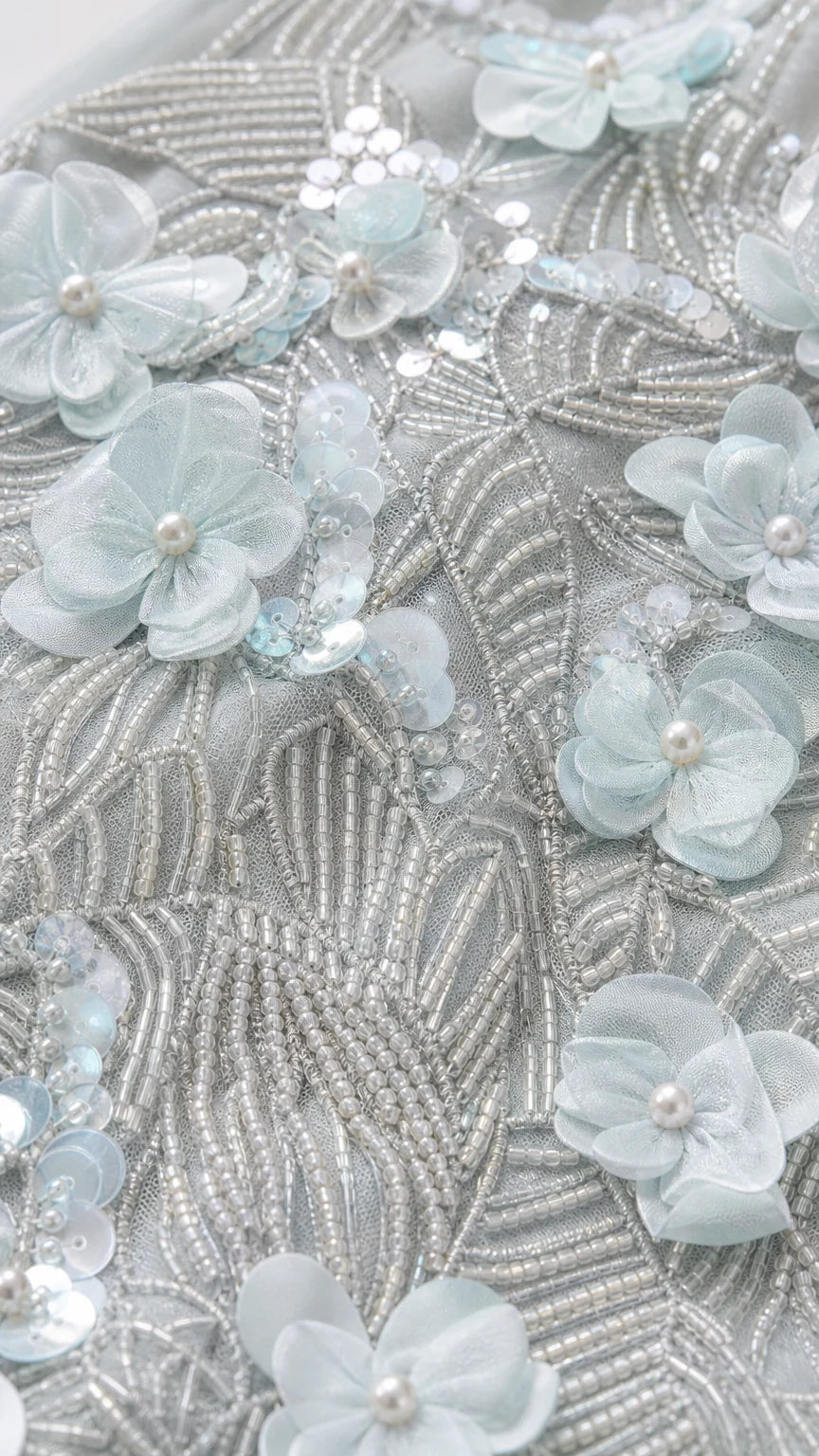 Close-up detail of Ice Blue 3D floral petals, pearls, and shimmering bead embroidery