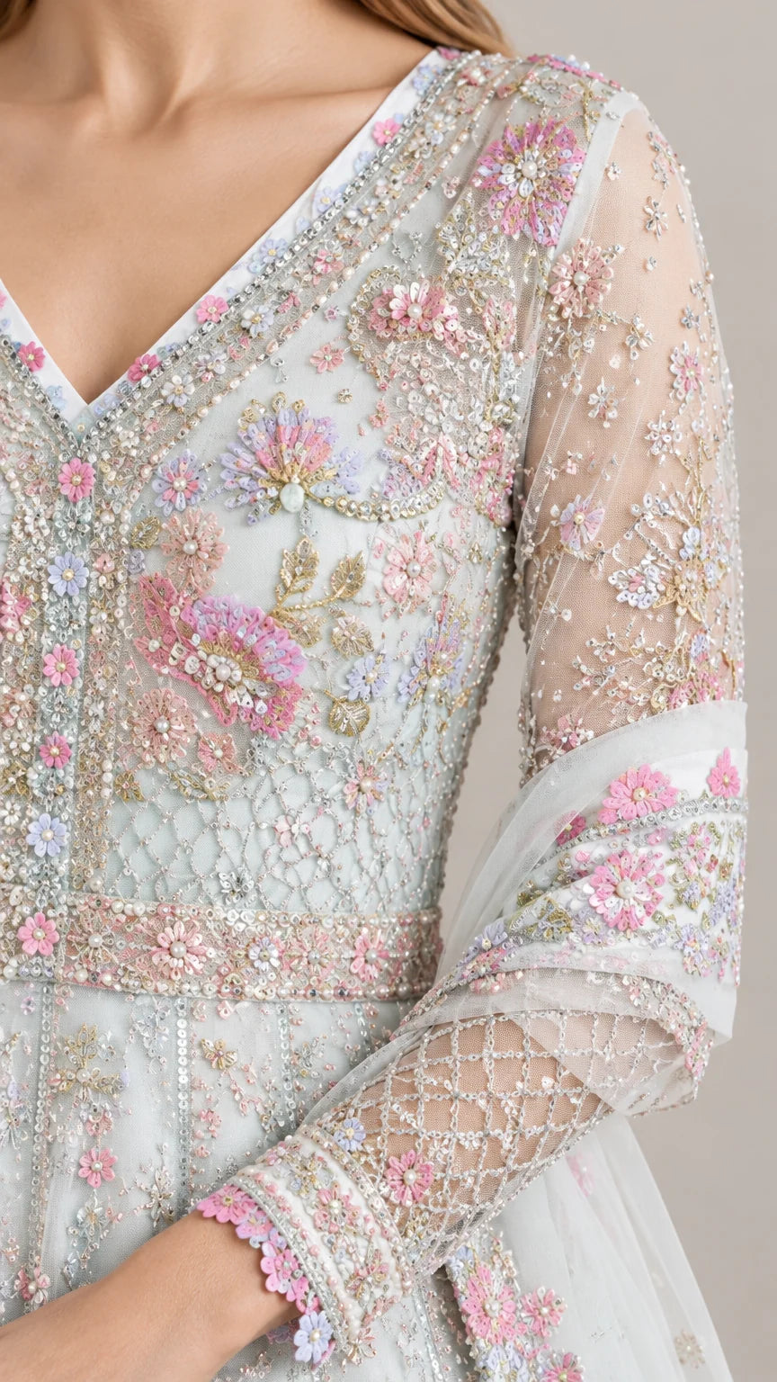 Close-up detail of sheer long sleeve and floral beaded embroidery on Ice Blue gown