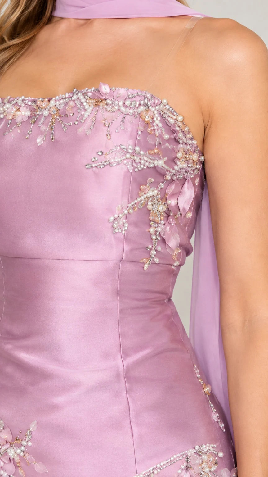 Close-up detail of delicate floral beading and embroidery on strapless neckline