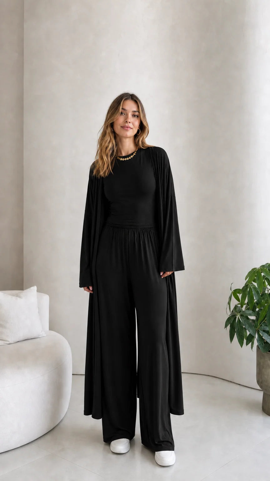Front view of model wearing the 3-piece duster cardigan and pants set in black