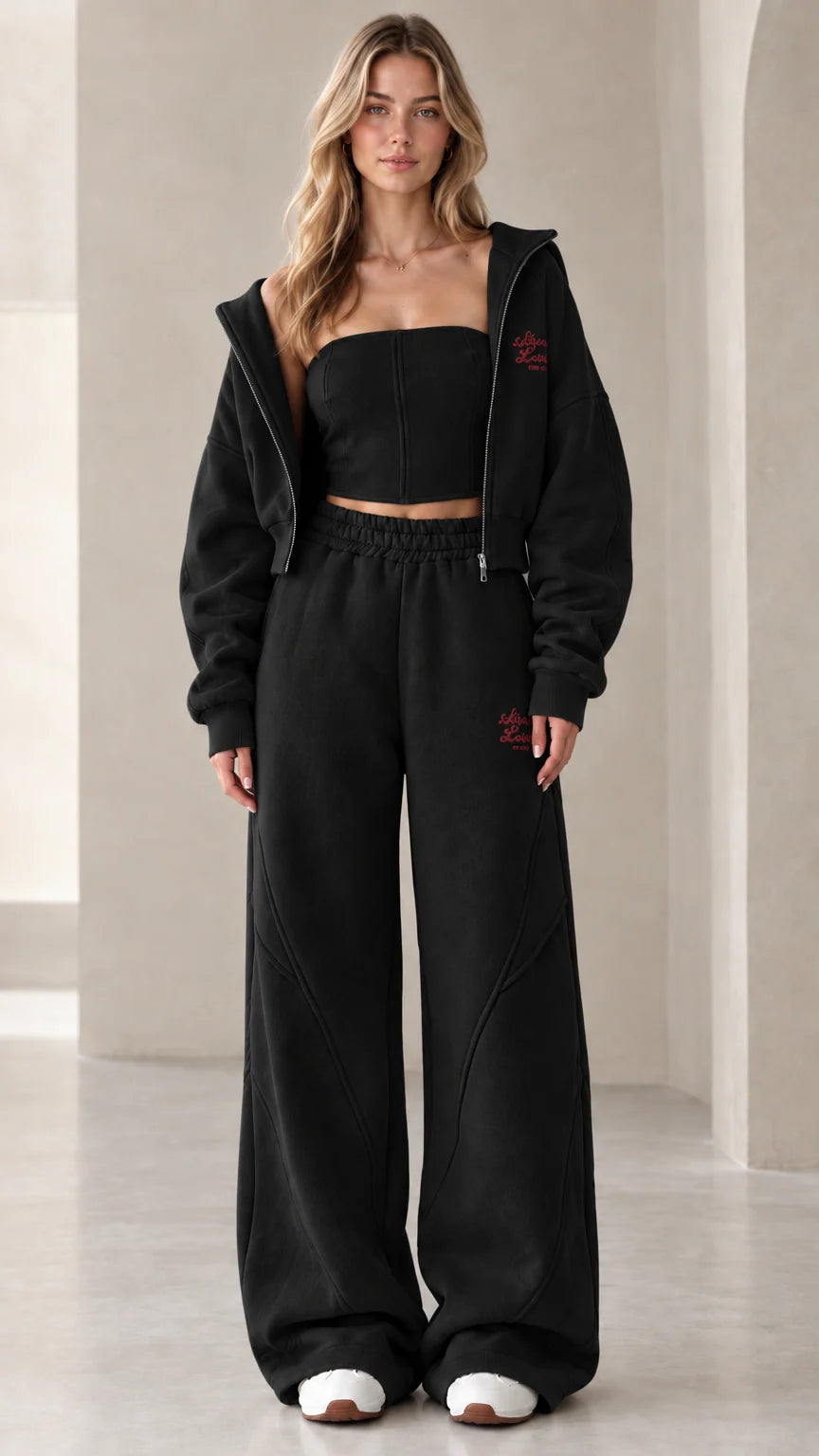 Full front view of model wearing the black 3-piece fleece tracksuit set