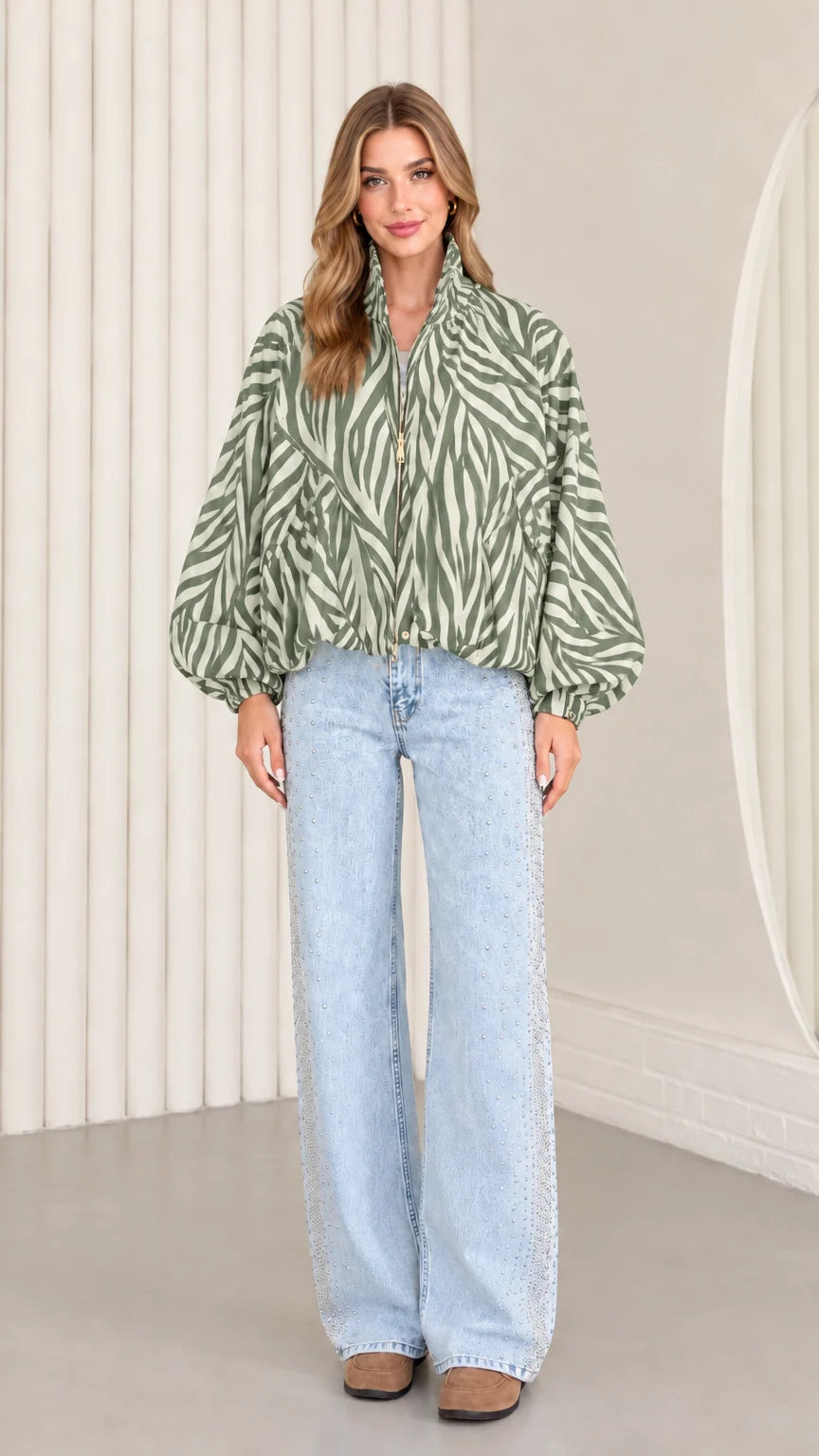 Model wearing sage green zebra print blouson jacket with front zip closure