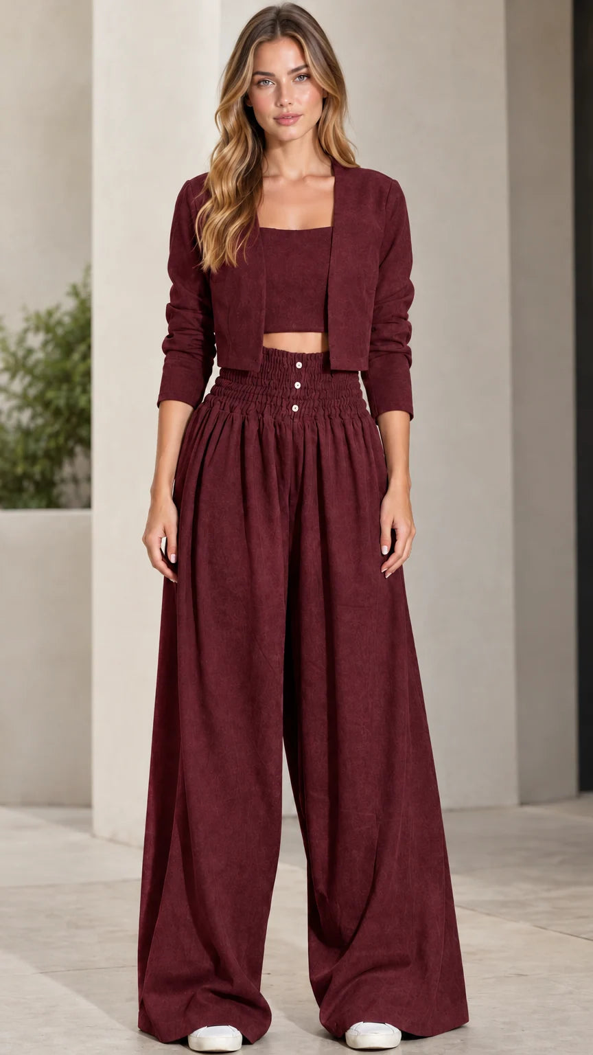 Front view of model wearing burgundy wine 3-piece crop top, jacket, and wide-leg pants set