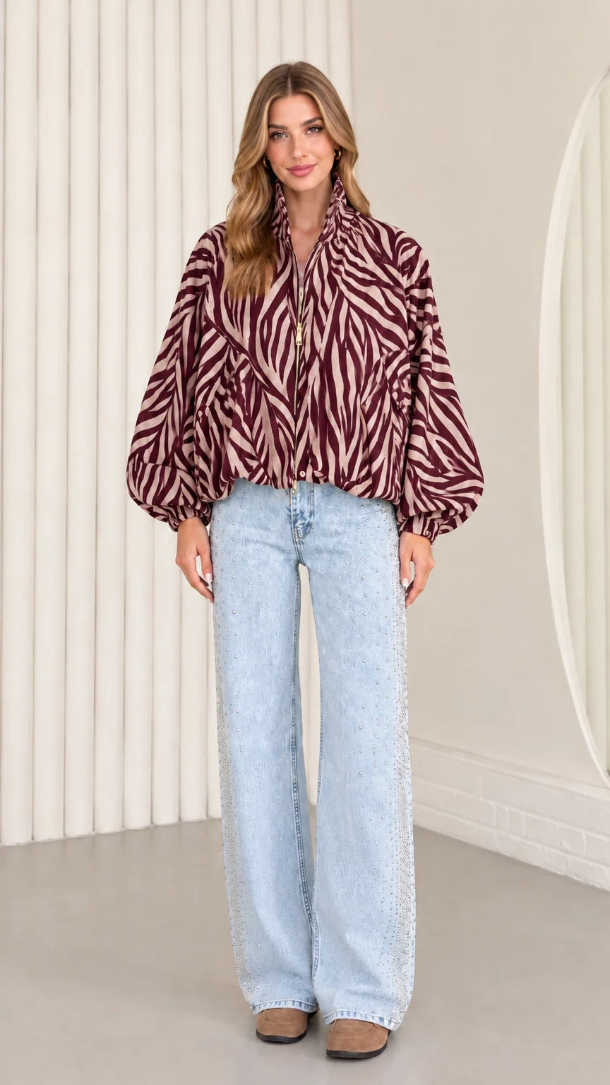 Model wearing rich burgundy zebra print balloon sleeve lightweight jacket