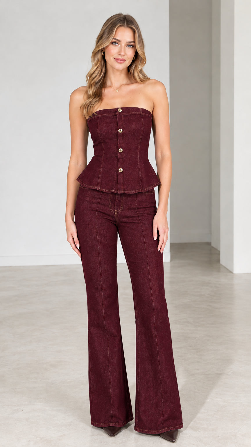 Model wearing burgundy red strapless peplum top and matching wine flare pants set