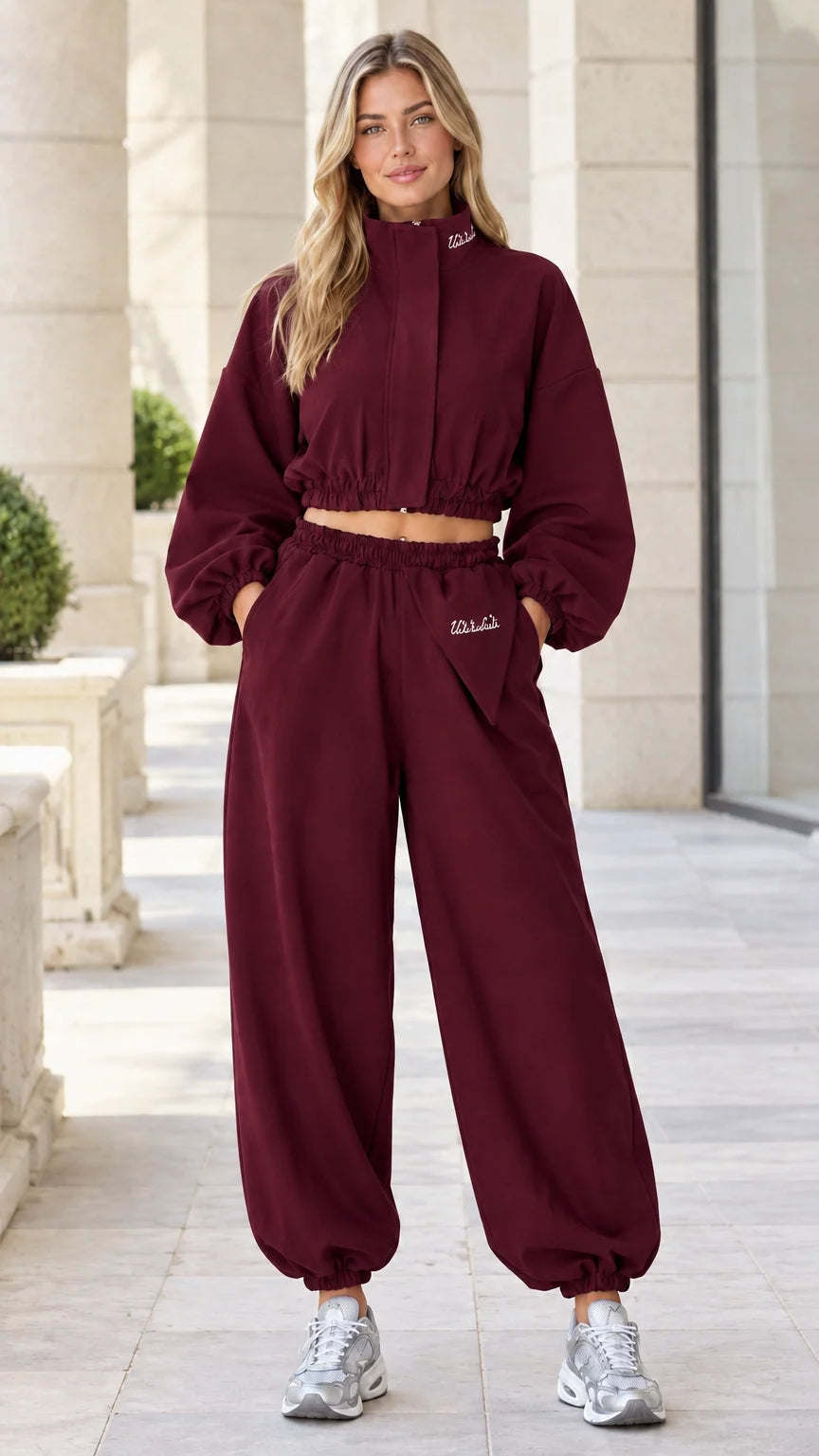 Model wearing Burgundy wine-colored cropped windbreaker jacket and jogger pants set