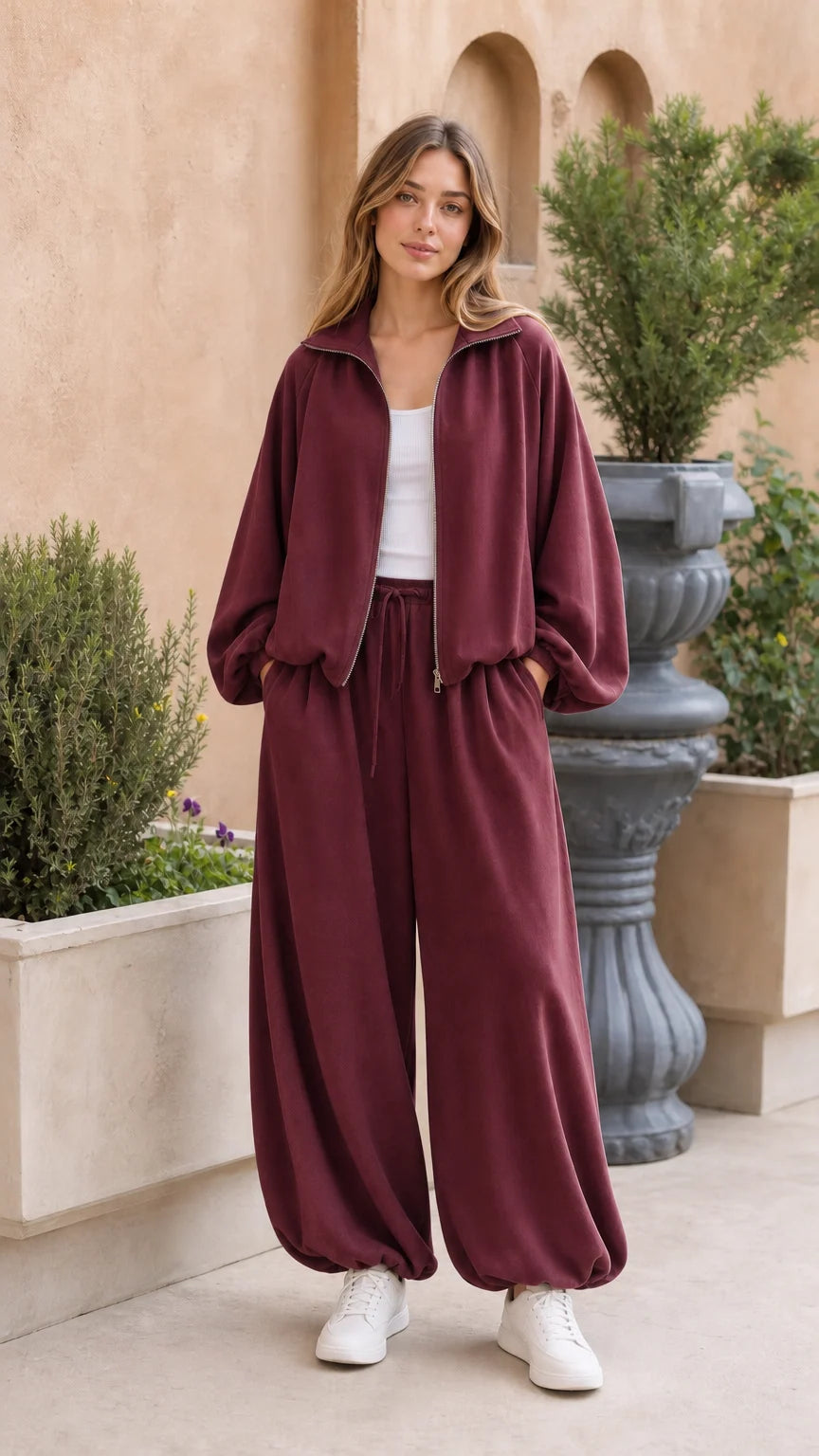 Full-body view of woman wearing burgundy 2-piece fleece tracksuit set