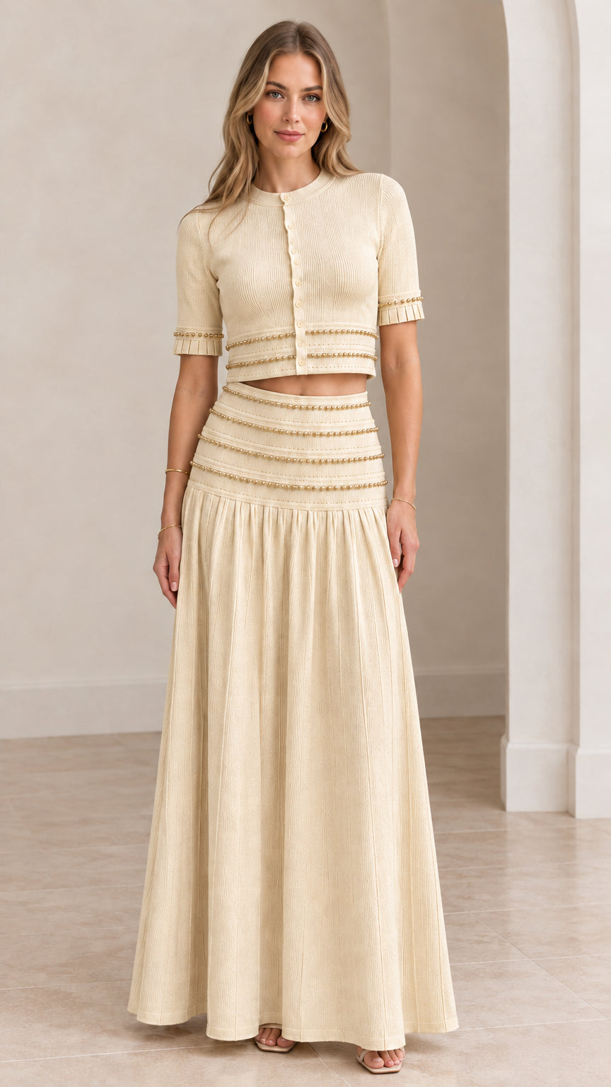 Model wearing cream beige beaded crop top and pleated maxi skirt set